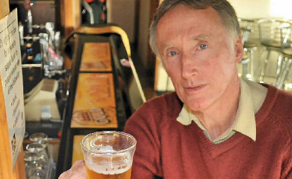 Turf Club president Jim Costello tries the new XXXX beer at the Member’s Bar.